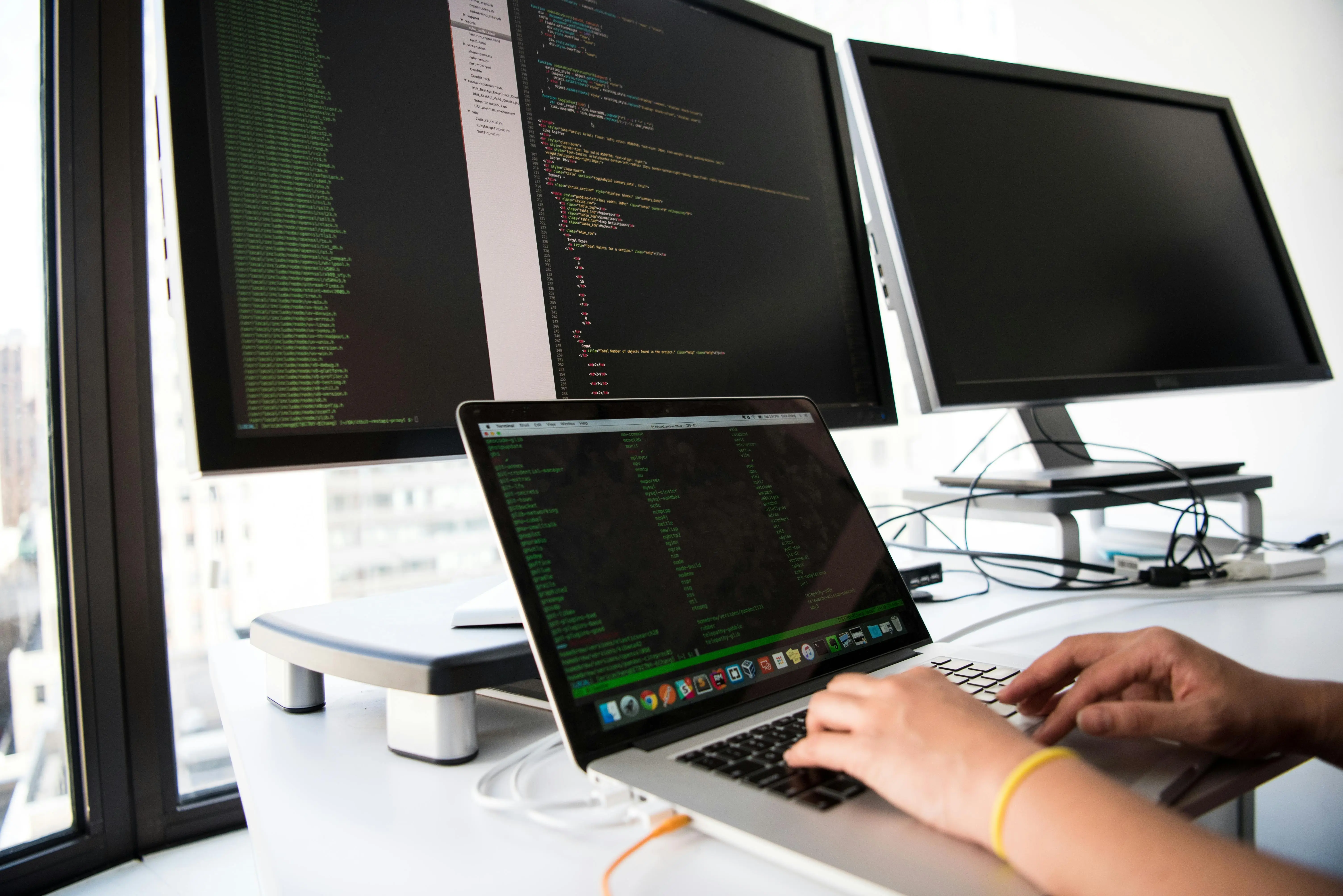 Multiple monitors showing the development process